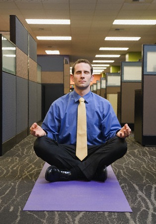 Businessman meditating in office